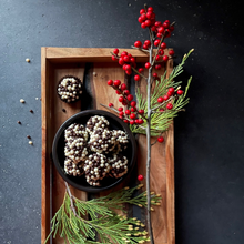 Rich chocolate bourbon balls handcrafted with Ben Holladay's Bottled-in-Bond Bourbon rolled in dark and white chocolate rice crispy pearls.  Pure Decadence!  