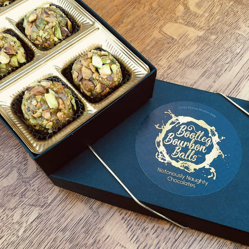 White chocolate, Sons of Erin Irish Whiskey topped pistachio pieces make this the perfect bourbon ball to celebrate everyting Irish for all your St. Patrick's Day celebrations.  Kansas City gifts.  Bourbon chocolates.  Bourbon balls.  Bootleg Bourbon Balls