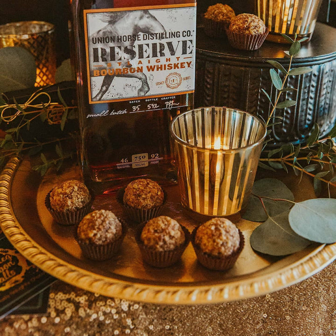 Bittersweet chocolate and toasted pecans are blended with Union Horse Distilling Co., Reserve Bourbon and rolled in a topping of pecans, caramelized with butter, dark brown sugar, maple syrup and cayenne perpper.  Kansas City gifts.  Bourbon chocolates, bourbon balls.  Bootleg Bourbon Balls