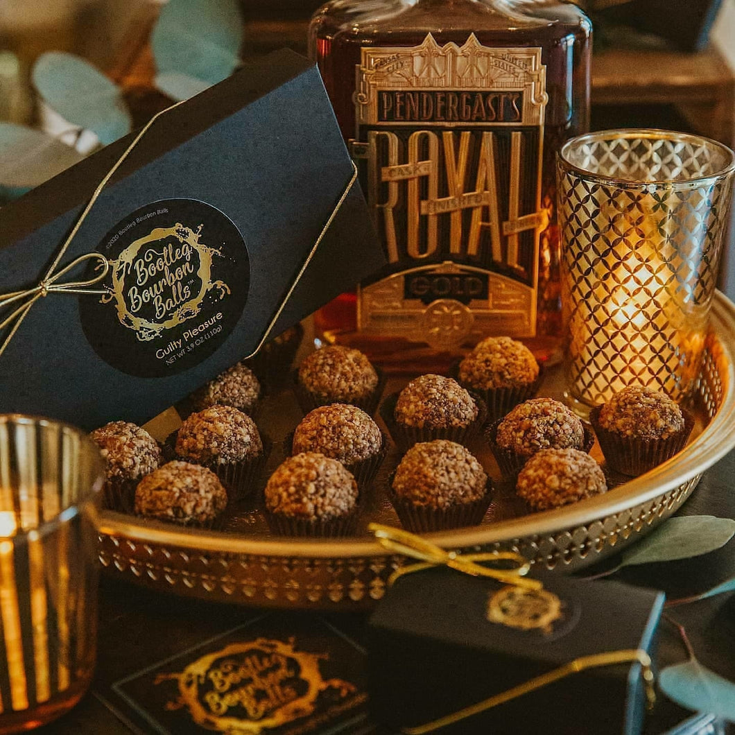 Bittersweet chocolate and Tom's Town Pendergast's Royal Gold Bourbon make this bourbon ball a fan favorite.  Finished in toasted, native pecans.  Your new Guilty Pleasure. Kansas City gifts.  Bourbon chocolates.  Bourbon balls.  Bootleg Bourbon Balls