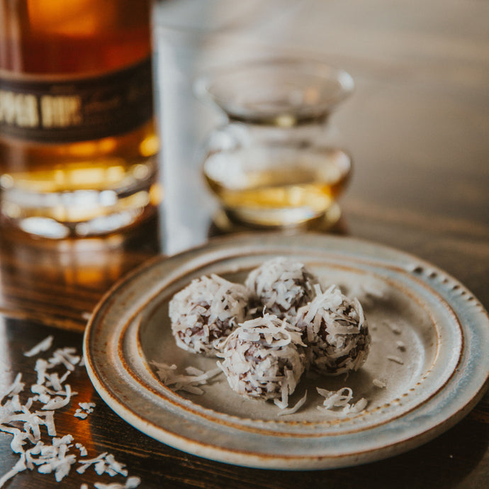 Copper Run Small Batch Gold Rum, dark 72% chocolate and toasted pecans are blended together and rolled in flaked coconut.  Just add umbrella, and be transported to the tropics.  Kansas City gifts.  Rum chocolates.  Rum balls.  Bootleg Bourbon Balls