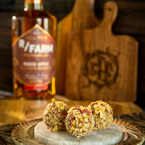 Fall is here and so is the Jacked-Up Apple bourbon ball.  Made with bittersweet chocolate, Baked Apple flavored whiskey from R/Farm Distilling Co, drizzled with a caramel sauce and rolled in red delicious apple chips.  Kansas City gifts.  Bourbon chocolate.  Bourbon balls.  Bootleg Bourbon Balls