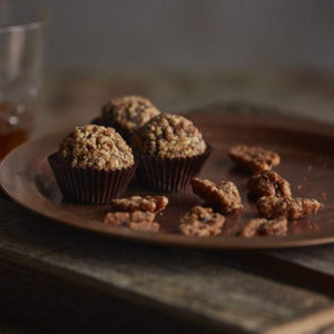 Hooch is handcrafted with Belgian bittersweet chocolate, toasted pecans and Union Horse Distilling Co. Reserve Bourbon.  Finished in a caramelized pecan crunch - brown sugar, maple syrup, butter and cayenne pepper. Southern Pecan Praline.  Kansas City Gifts.  Kansas City Chocolates.  Bourbon Chocolate.
